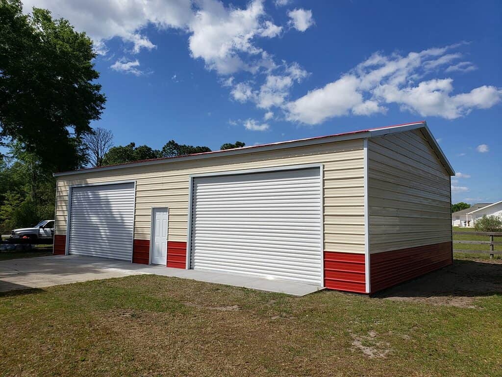 30x50 Steel Building, with wainscot siding Red and cream With two white garage doors Probuilt structures robin sheds Steel buildings for sale in central florida citrus county and marion county Finished pictures of double garage doors exterior