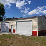 30x50 Steel Building, with wainscot siding Red and cream With two white garage doors Probuilt structures robin sheds Steel buildings for sale in central florida citrus county and marion county Finished pictures of double garage doors exterior