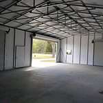 30x50 Steel Building, with wainscot siding Red and cream With two white garage doors Probuilt structures robin sheds Steel buildings for sale in central florida citrus county and marion county Three garage doors storage building finished pictures